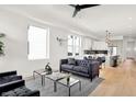 Modern living room with a black sofa, two black chairs, and large windows for natural light at 2015 Yandes St, Indianapolis, IN 46202