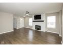 Bright living room with a ceiling fan, fireplace, and wood-look flooring at 2080 Bridlewood Dr, Franklin, IN 46131