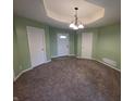 Neutral living room features plush carpeting, modern lighting, and three entryways at 21 Watson Dr, Trafalgar, IN 46181