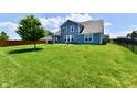 Expansive backyard featuring lush green lawn and mature tree, perfect for outdoor enjoyment at 21536 Gisborne Dr, Noblesville, IN 46062