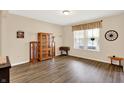 Bright living area with modern floors, natural light from a large window, and classic wooden furnishings at 2282 Creekland Dr, Columbus, IN 47201