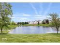 Scenic view of pond surrounded by lawn and homes in the distance at 2499 Blue Ridge Dr, Greenwood, IN 46143