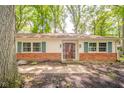 Inviting front entrance with brick accents and a well-maintained walkway at 2613 W Queensbury Rd, Muncie, IN 47304
