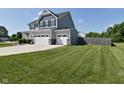 Large lawn and three-car garage enhance the curb appeal of this home at 2734 Chalbury Dr, Plainfield, IN 46168