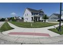 Well-manicured front yard and charming home exterior on a sunny day at 2734 Chalbury Dr, Plainfield, IN 46168
