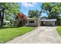 Inviting single-story home featuring a carport and lush green lawn, showcasing its appealing curb appeal at 2811 Beech Dr, Columbus, IN 47203