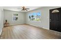 Bright living room with large windows, modern flooring, and a welcoming entrance door, creating a comfortable space at 2811 Beech Dr, Columbus, IN 47203