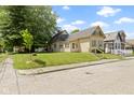 Quaint home on well-manicured lawn, showcasing a cozy and inviting neighborhood at 29 E Caven St, Indianapolis, IN 46225