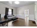 Spacious living room featuring hardwood floors, natural light, and a neutral color palette at 29 E Caven St, Indianapolis, IN 46225