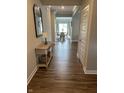 Inviting hallway with wood floors leading to dining room and other spaces at 3068 Gibbert Ln, Westfield, IN 46074