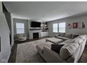 Comfortable living room features a fireplace, large sectional, and bright windows at 3068 Gibbert Ln, Westfield, IN 46074