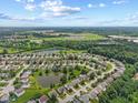 An aerial view of a suburban neighborhood featuring several ponds and lush green landscaping at 3341 Carica Dr, Indianapolis, IN 46203
