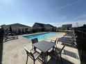 Bright community pool with ample seating, loungers, and a covered patio for shade on sunny days at 3443 Thomas Jefferson St, Westfield, IN 46074