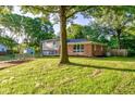 Charming two-story home with a brick and siding exterior, a spacious yard, and mature trees at 3518 Woodale Rd, Indianapolis, IN 46234