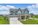 Two-story blue home with a brick facade, attached garage, and a neatly landscaped front yard at 3650 Merchmont Rd, Bargersville, IN 46106
