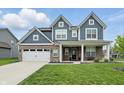 Attractive home boasts a brick and siding exterior, with a welcoming front porch and well-maintained lawn at 3650 Merchmont Rd, Bargersville, IN 46106