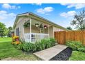 Charming covered front porch with a white railing and colorful flowers at 405 N Church St, Mooresville, IN 46158