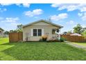 Well maintained one-story home with green grass and a charming yellow exterior at 405 N Church St, Mooresville, IN 46158