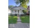 Traditional one-story home featuring a cozy front porch and mature landscaping at 416 W 21St St, Anderson, IN 46016