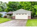 Charming single-story home with a well-manicured lawn and an attached two-car garage at 4309 Clayburn Dr, Indianapolis, IN 46268