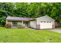 Charming single-story home with a well-manicured lawn and an attached two-car garage at 4309 Clayburn Dr, Indianapolis, IN 46268