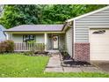 Charming single-story home with a well-manicured lawn and landscaped yard at 4309 Clayburn Dr, Indianapolis, IN 46268
