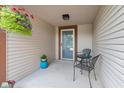 Cozy front porch featuring seating, decorative plants, and a hanging flower basket at 444 Austin Dr, Avon, IN 46123