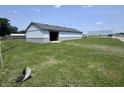 Exterior shot of home with yard, open door, and blue skies at 4503 W Minnesota St, Indianapolis, IN 46241