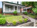 Charming home with a landscaped front yard and inviting front porch at 545 Fletcher Ave, Indianapolis, IN 46203