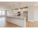 Bright kitchen featuring stainless appliances, subway tile backsplash, and a large island at 6038 Windsor Dr, McCordsville, IN 46055