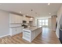 Bright, open kitchen with a large island, modern light fixtures, and stainless steel appliances at 6038 Windsor Dr, McCordsville, IN 46055