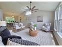 Open-concept living room with dining area, vaulted ceilings, and contemporary furnishings at 6369 Kelsey Dr, Indianapolis, IN 46268
