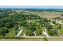 Expansive aerial view showcasing property lines surrounded by farmland and beautiful, mature trees at 7516 S County Road 300 W, Clayton, IN 46118