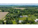 Aerial view of the property showing acreage with a house and outbuilding at 7516 S County Road 300 W, Clayton, IN 46118