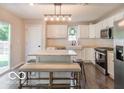 Bright eat-in kitchen boasts white cabinetry, butcher block countertops, and a stylish marble island at 774 Courtney Cir, Danville, IN 46122