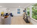 Bright and stylish living room featuring large windows, hardwood floors and comfortable seating at 8246 Windcombe Blvd, Indianapolis, IN 46240