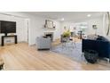 Bright living room featuring hardwood floors, fireplace, and modern decor at 8246 Windcombe Blvd, Indianapolis, IN 46240