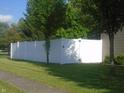 White vinyl privacy fence encloses the backyard, providing security and seclusion at 8301 Wheatfield Dr, Camby, IN 46113
