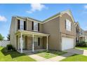 This angle showcases the home's architecture and curb appeal on a sunny day at 8301 Wheatfield Dr, Camby, IN 46113