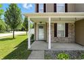 A close up of the front porch showing the brick facade and covered entryway at 8301 Wheatfield Dr, Camby, IN 46113