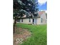 Spacious backyard features a well-manicured lawn and mature trees, providing ample space at 8326 Alcona Dr, Indianapolis, IN 46237