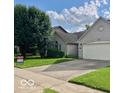 Well-maintained home with lush lawn, mature trees, and a convenient two-car garage at 8326 Alcona Dr, Indianapolis, IN 46237