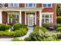Welcoming front entrance with a decorative door, white columns, and beautiful landscaping at 10480 Stonegate Dr, Fishers, IN 46040