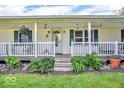 Inviting front porch with a well-manicured garden offering curb appeal and a warm welcome at 10705 N State Road 267, Brownsburg, IN 46112