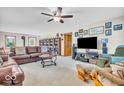 Comfortable living room with plush seating, a ceiling fan, and plenty of natural light at 10705 N State Road 267, Brownsburg, IN 46112