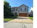 Charming two-story home featuring a two-car garage, tidy landscaping, and classic curb appeal at 10775 Cyrus Dr, Indianapolis, IN 46231