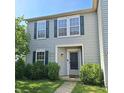 The front exterior of this home features well-maintained landscaping, complemented by gray siding and dark shutters at 10775 Cyrus Dr, Indianapolis, IN 46231