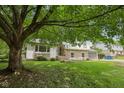Charming two-story home with stone accents, a well-manicured lawn, and mature trees for shade at 10778 Haverstick Rd, Carmel, IN 46033