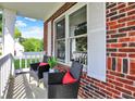 Cozy brick front porch featuring comfortable seating, perfect for enjoying a relaxing outdoor experience at 1099 Saratoga Cir, Carmel, IN 46280