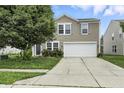 Inviting two-story home with a well-maintained lawn and a two-car garage at 1236 N Aberdeen Dr, Franklin, IN 46131
